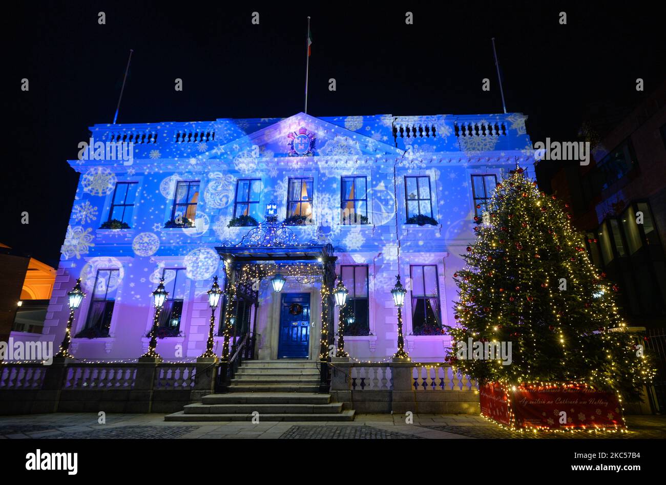 A Christmas tree in front of illuminated Dublin's Mansion House, a part