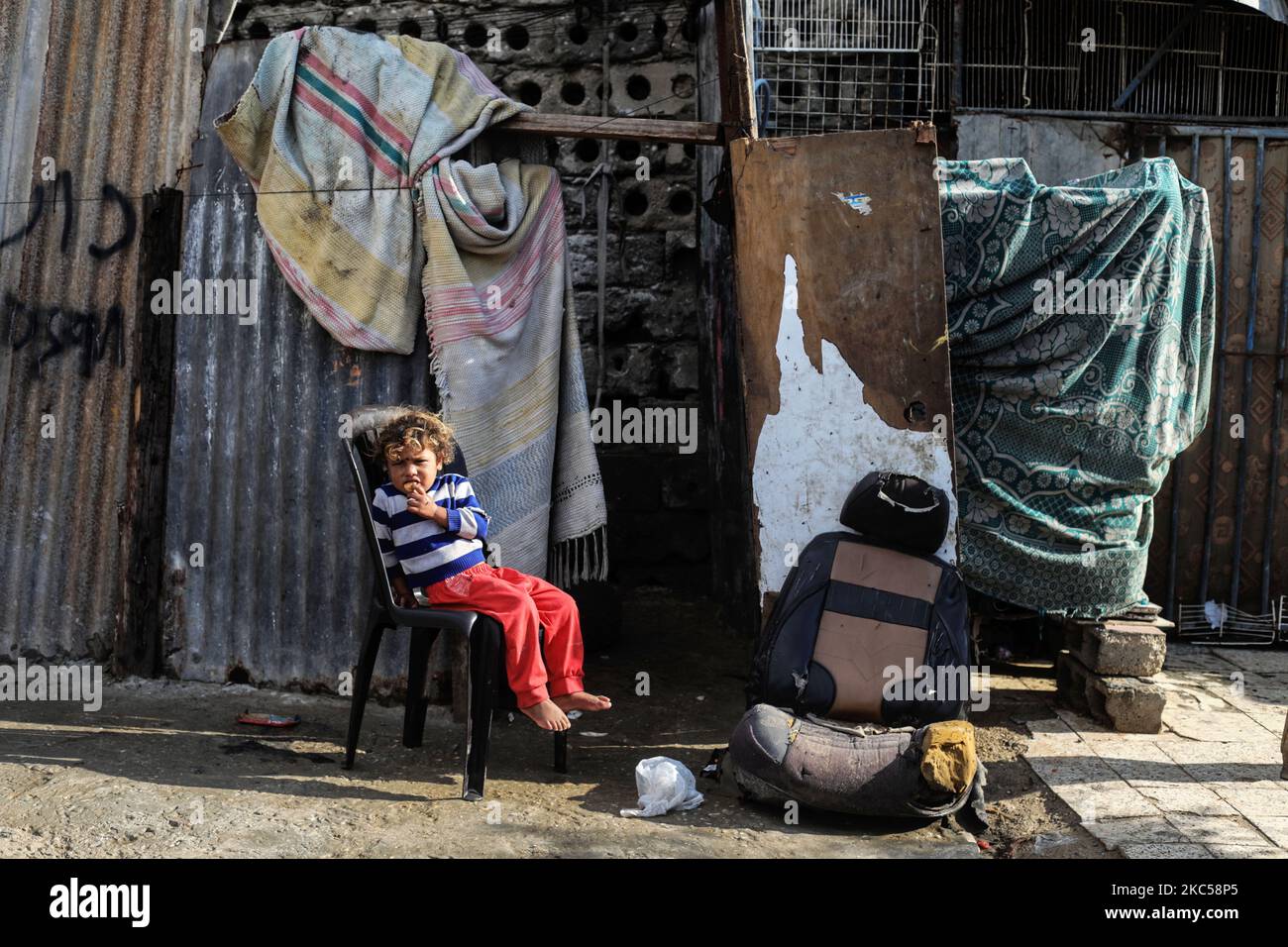 A Palestinian girl outside her family house following heavy rain in a ...