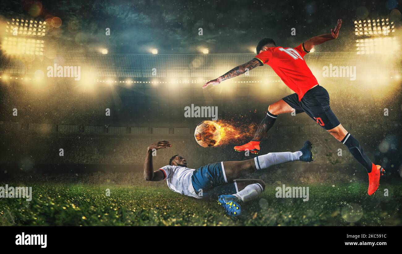 Soccer scene at night match with player in a red uniform kicking a fiery ball with power Stock