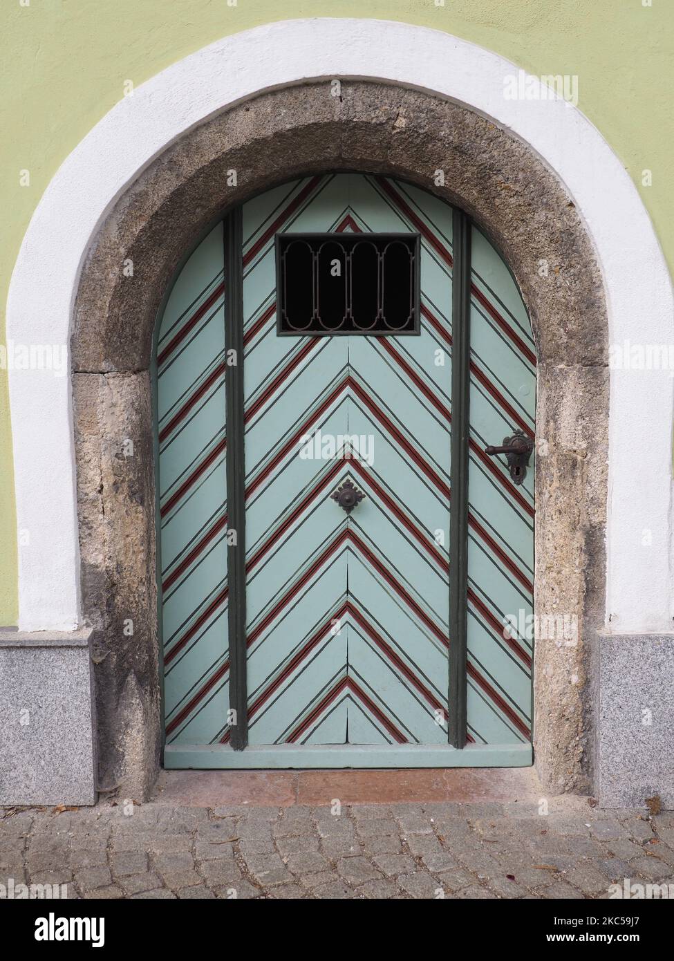 A vertical shot of an old round arch door Stock Photo