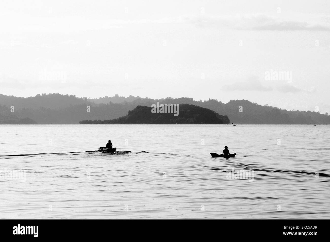 Traditional fishermen fishing in small boats in the waters of Halmahera, North Maluku, Indonesia Stock Photo