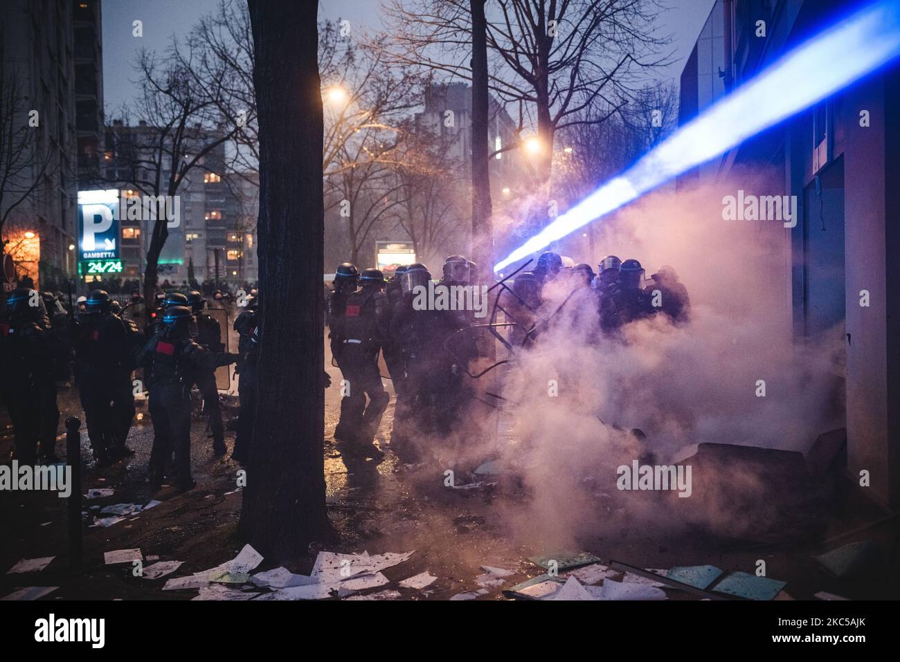 Anti-riot police officers who are trying to disperse the black bloc are targeted by lasers to dazzle them on 5 December 2020, when the third day of mobilisation against the so-called 'Global Security' bill was taking place in France. In Paris several thousand demonstrators gathered at Porte de Lilas to protest against article 24 banning the distribution of police images on social networks and article 23 on the use of drones by the police and facial recognition. Quickly Black Bloc took the lead of the demonstration and confronted the police making the demonstration never arrived at Place de la  Stock Photo