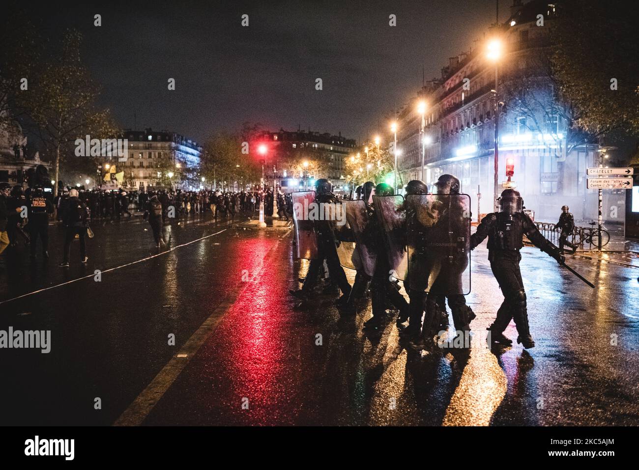 Anti-riot police officers are trying to disperse the numerous demonstrators who gathered in the early evening on the Place de la République on December 5, 2020, when the third day of mobilization against the so-called 'Global Security' bill was taking place in France. In Paris several thousand demonstrators gathered at Porte de Lilas to protest against article 24 prohibiting the dissemination of police images on social networks and article 23 on the use of drones by the police and facial recognition. Quickly Black Bloc took the lead of the demonstration and confronted the police making the dem Stock Photo