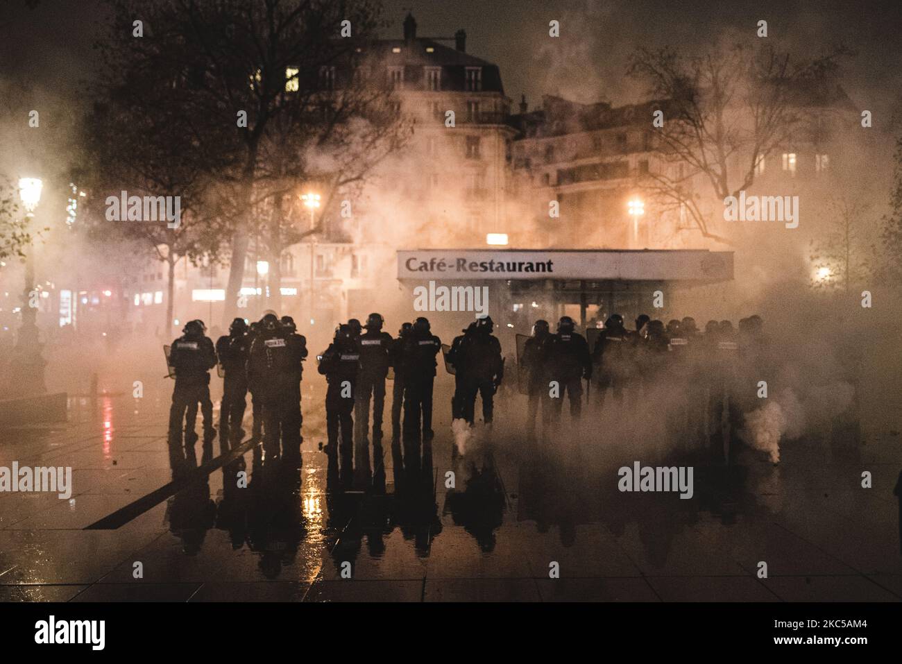 Anti-riot police officers are trying to disperse the numerous demonstrators who gathered in the early evening on the Place de la République on December 5, 2020, when the third day of mobilization against the so-called 'Global Security' bill was taking place in France. In Paris several thousand demonstrators gathered at Porte de Lilas to protest against article 24 prohibiting the dissemination of police images on social networks and article 23 on the use of drones by the police and facial recognition. Quickly Black Bloc took the lead of the demonstration and confronted the police making the dem Stock Photo