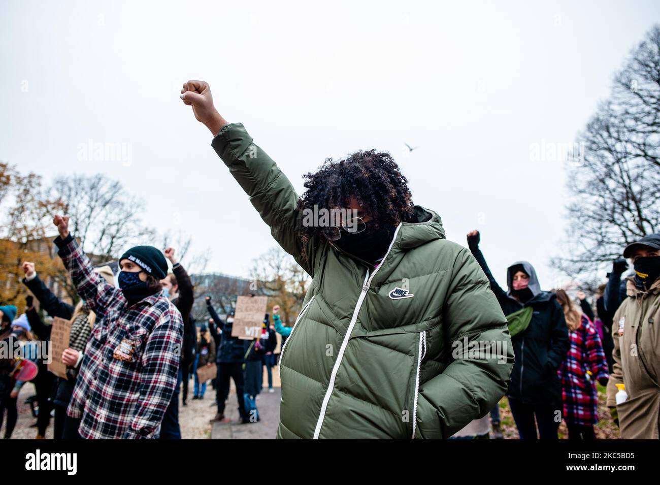 People are seen raising their fists in the air as a symbol of Black 