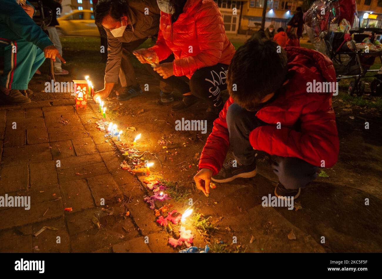 People gather at the Park Way avenue in Bogota to light candles on the Day of the Little Candles