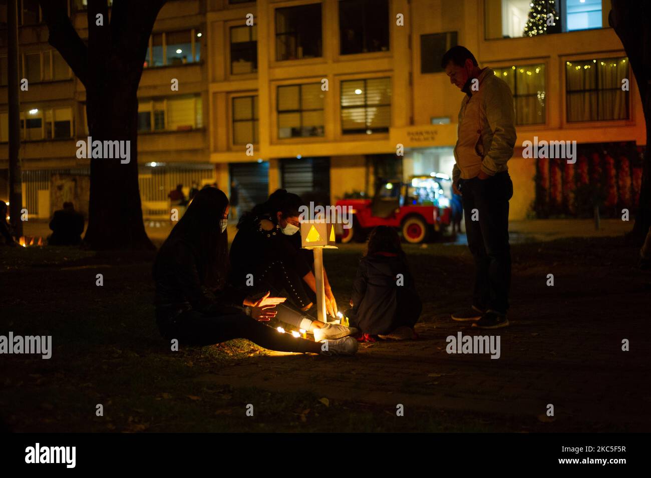 People gather at the Park Way avenue in Bogota to light candles on the