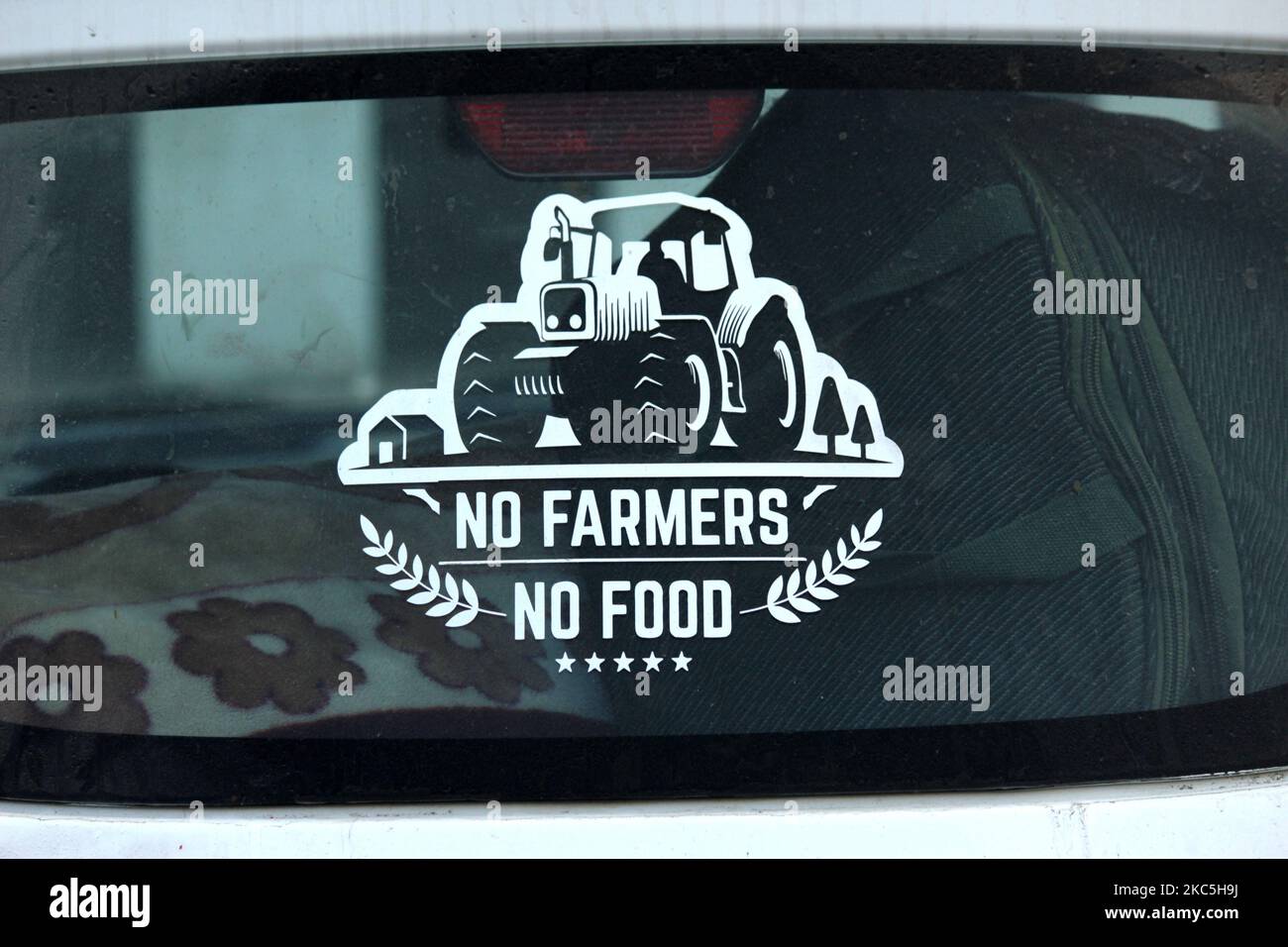 A sticker on a car reads 'No Farmers, No Food' at the blocked highway as farmers protest against recent farm bills near Ghazipur at the Delhi-Uttar Pradesh state border, India on December 9, 2020. (Photo by Mayank Makhija/NurPhoto) Stock Photo