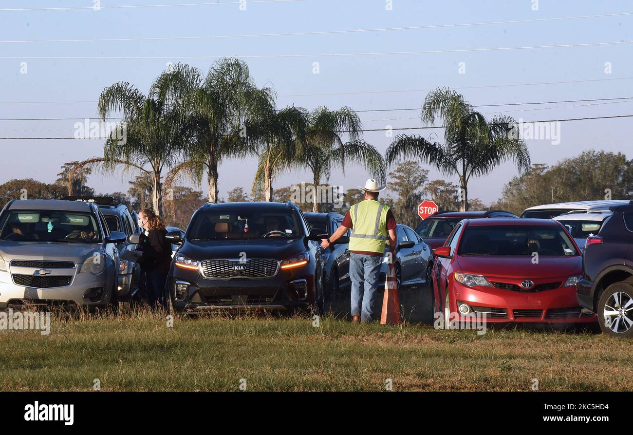 People line up in their cars to receive food assistance at the Share