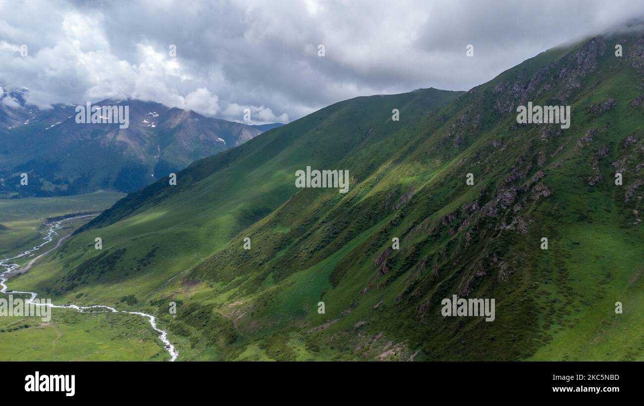 A gorgeous view of massive green hills during a cloudy day Stock Photo ...