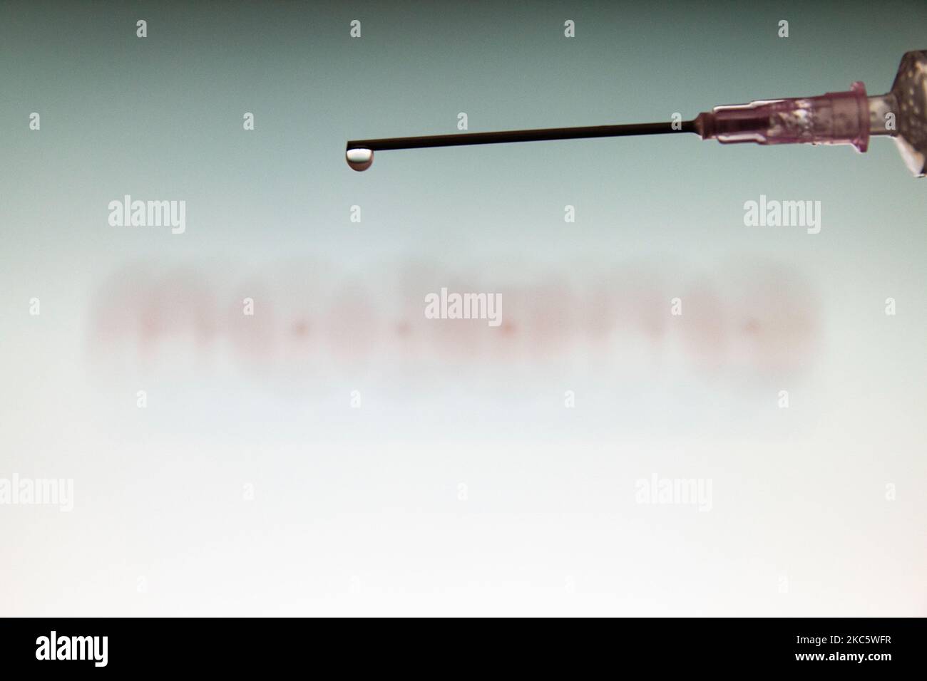 Photo illustration of a medical syringe with a needle seen in front of