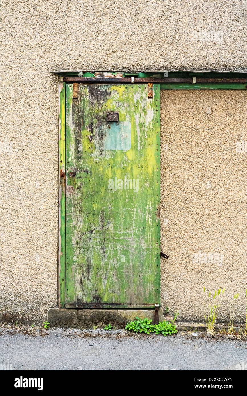 Building entrance with green sliding door Stock Photo - Alamy