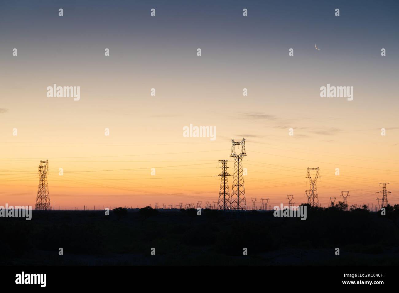 The silhouettes of transmission towers at sunset Stock Photo - Alamy