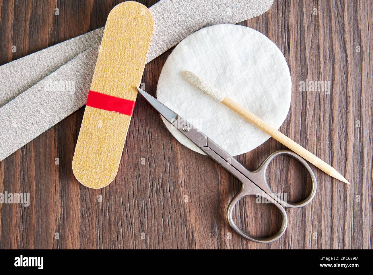 Flat lay template with manicure tools, scissors, nail file, cotton pad on the worker table. Health and body care backgrounds Stock Photo