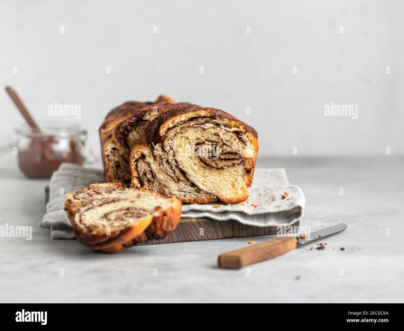 Chocolate yeast cake babka, swirl marbled brioche with chocolate on gray background with text space Stock Photo