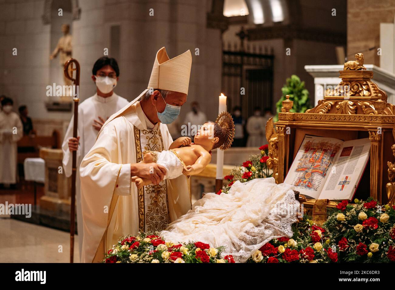 Manila Auxiliary Broderick Pabillo kisses the image of an infant