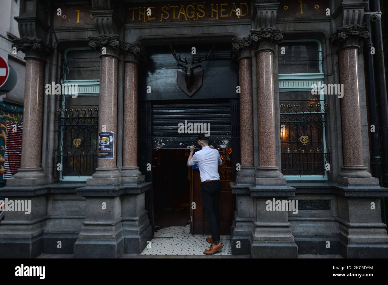A barman seen closing a pub in Dublin city center. From today 3pm, all