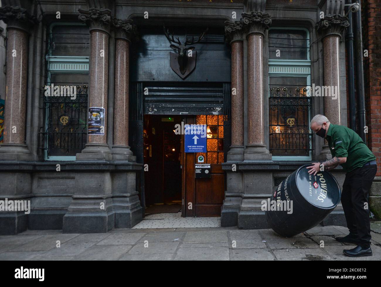 A barman, collecting a barrel from outside a pub in Dublin city center