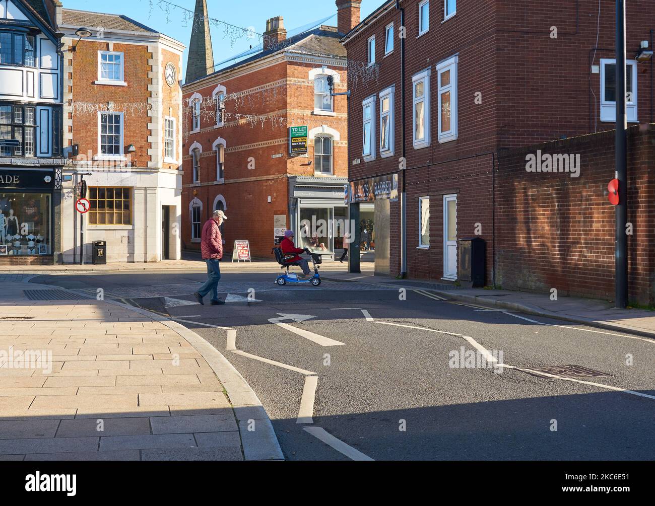 Old people crossing a street in Uttoxeter, Staffordshire, UK Stock Photo