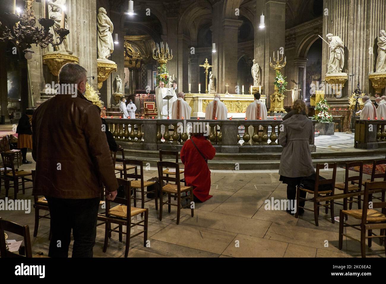 People attend the Midnight Mass at the Saint Sulpice Church in Paris on