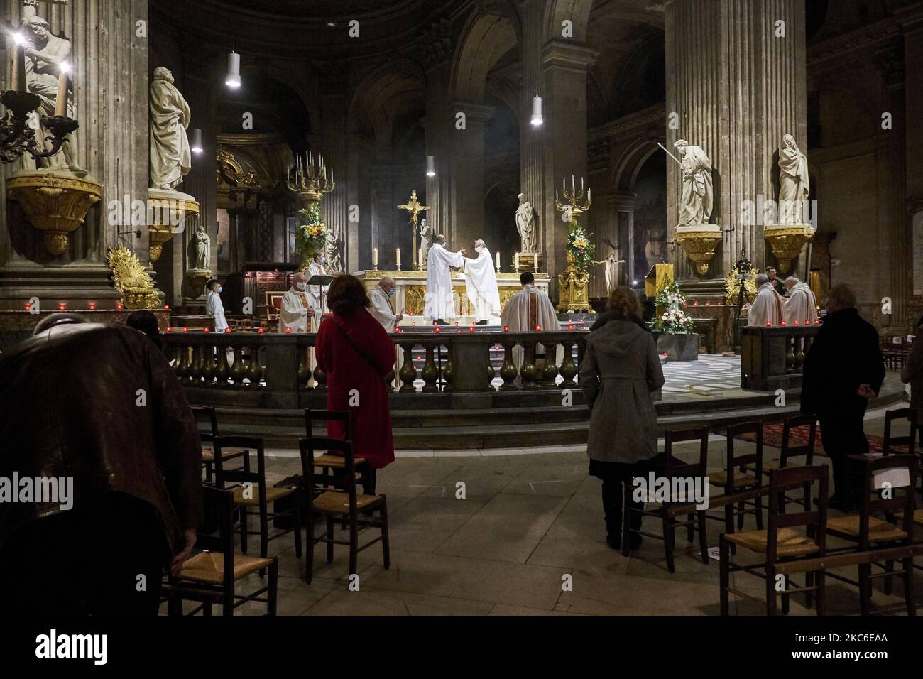 People attend the Midnight Mass at the Saint Sulpice Church in Paris on December 24, 2020