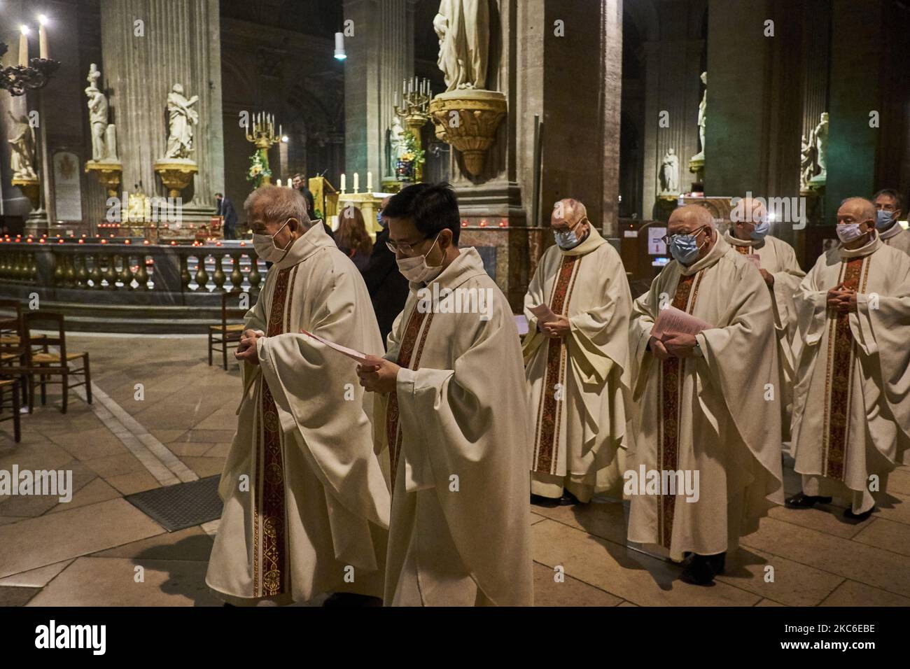 People attend the Midnight Mass at the Saint Sulpice Church in Paris on