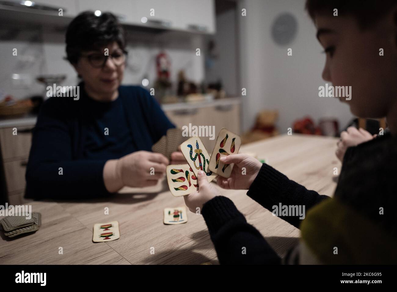 Isa De Palma, Davide Pischettola's mother-in-law plays cards with her nephew Antonio Pischettola during his daughter's visit on December 26, 2020. During the Christmas holidays, the Government has provided for the possibility, once a day, to move to visit relatives or friends, even to other Municipalities, but always and only within the same Region, between 5 and 22 and in the maximum limit of two people. Those who move will still be able to bring with them their children under the age of 14 and the disabled or non self-sufficient people who live with them. (Photo by Davide Pischettola/NurPhot Stock Photo