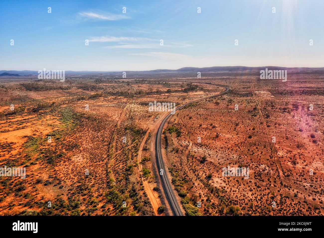 Single railway track railroad in red soil outback to Broken Hill of Far West NSW in Australia - aerial landscape. Stock Photo