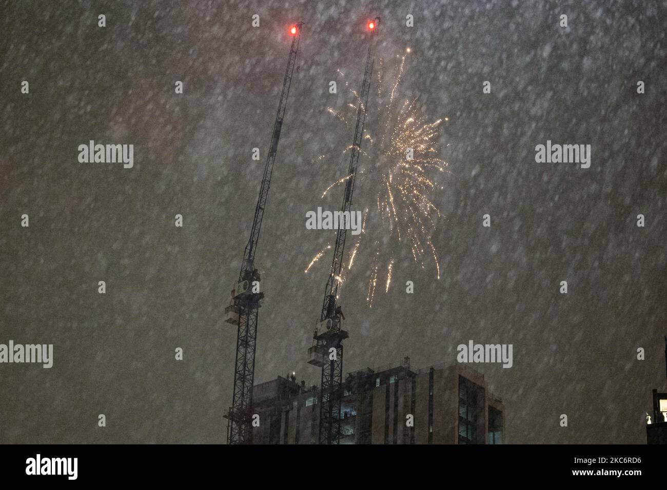 People set off fireworks from an unfinished block of apartments to