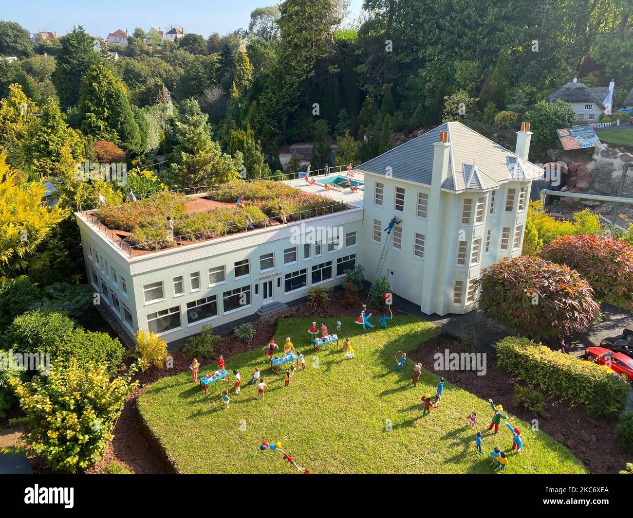 An aerial drone shot of a school or a kindergarten with kids playing ...