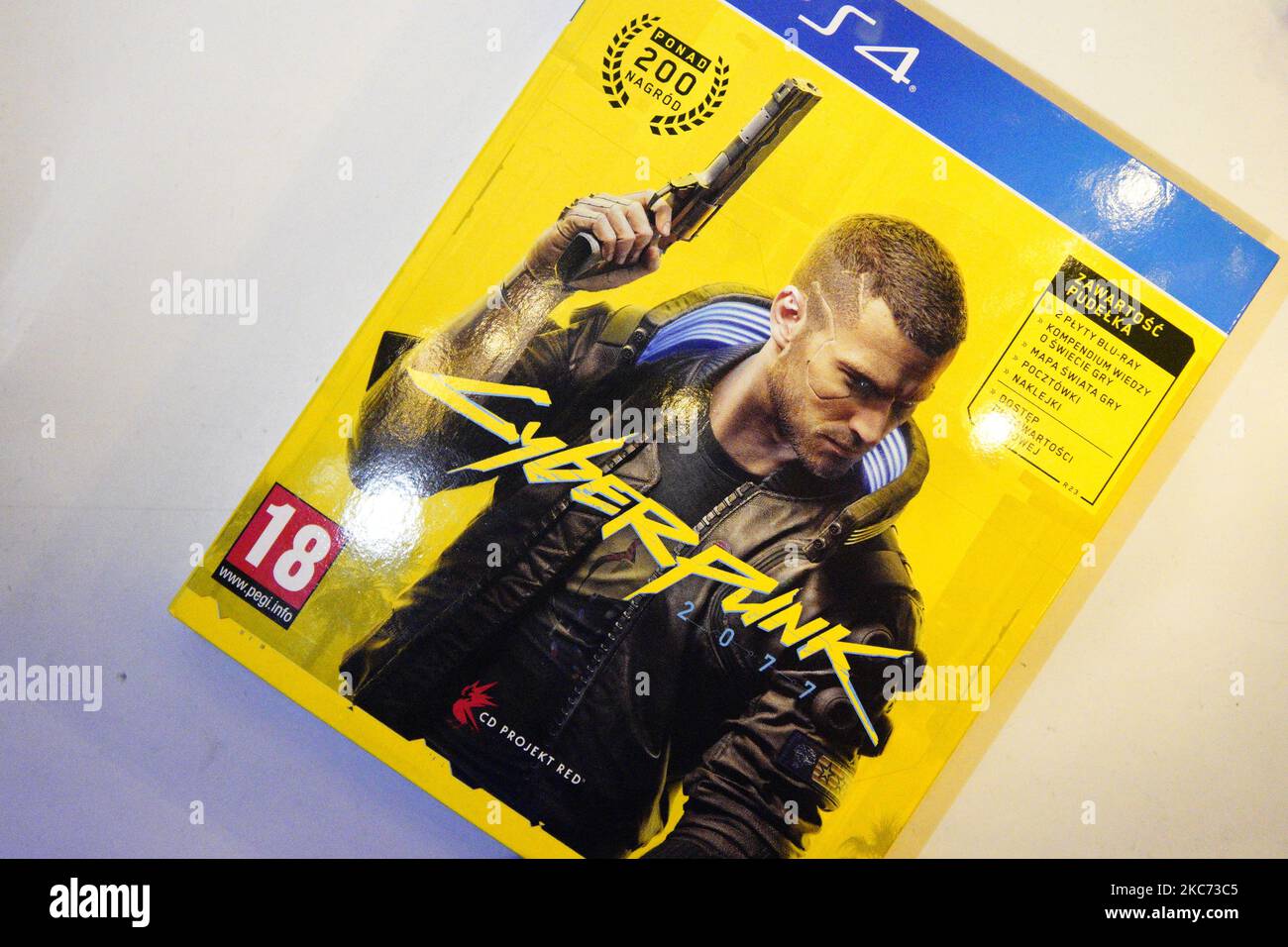 The Cyberpunk 2077 game box is seen in Warsaw, Poland on January 6, 2021. Cyberpunk 2077 was hailed as the 2020's most anticipated game however glitches in the game's first release led to deep disappointment with fans. After nearly a decade of hyped anticipation critics blaimed bugs in the game on mismangement within the company with investors threatening a class action suit. The large amount of serious complaints even led Sony to offer Playstation customers a refund despite this not being part of the terms of service. (Photo by Jaap Arriens/NurPhoto) Stock Photo