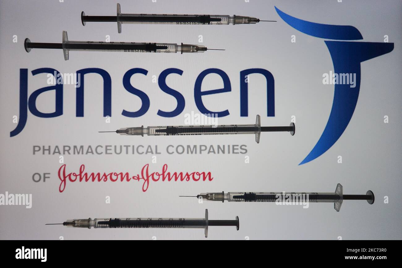 An illustrative image of medical syringes in front of Janssen Pharmaceutica, and Johnson and Johnson logos displayed on a screen. On Friday, January 8, 2020, in Dublin, Ireland. (Photo by Artur Widak/NurPhoto) Stock Photo
