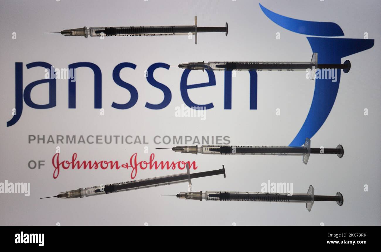 An illustrative image of medical syringes in front of Janssen Pharmaceutica, and Johnson and Johnson logos displayed on a screen. On Friday, January 8, 2020, in Dublin, Ireland. logo displayed on a screen. (Photo by Artur Widak/NurPhoto) Stock Photo
