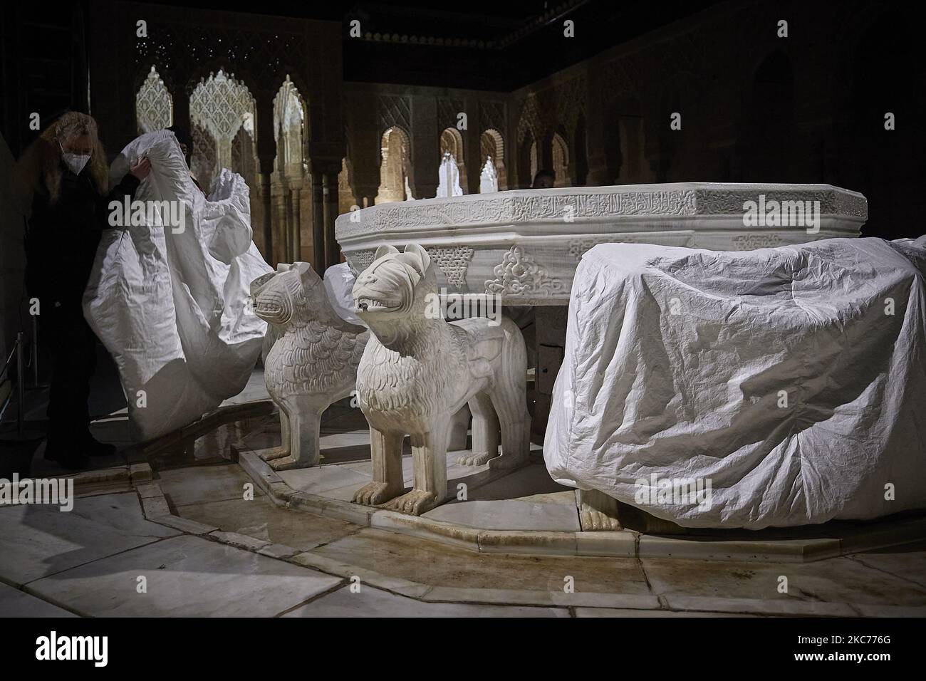 Alhambra workers protect the lions of the famous Fountain of the Lions