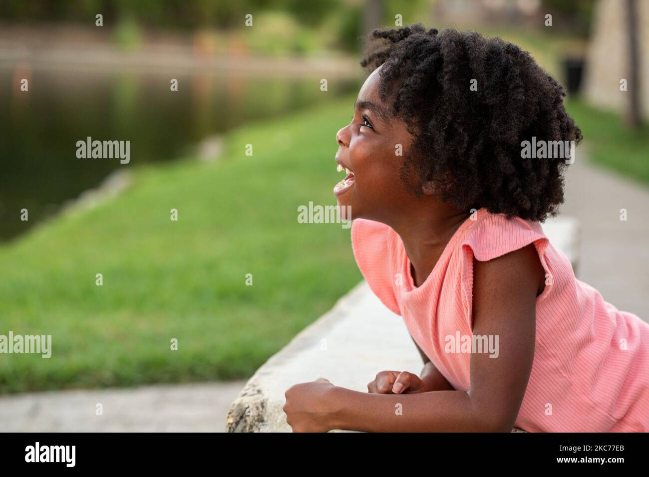African Amerian little girl smiling outside Stock Photo - Alamy