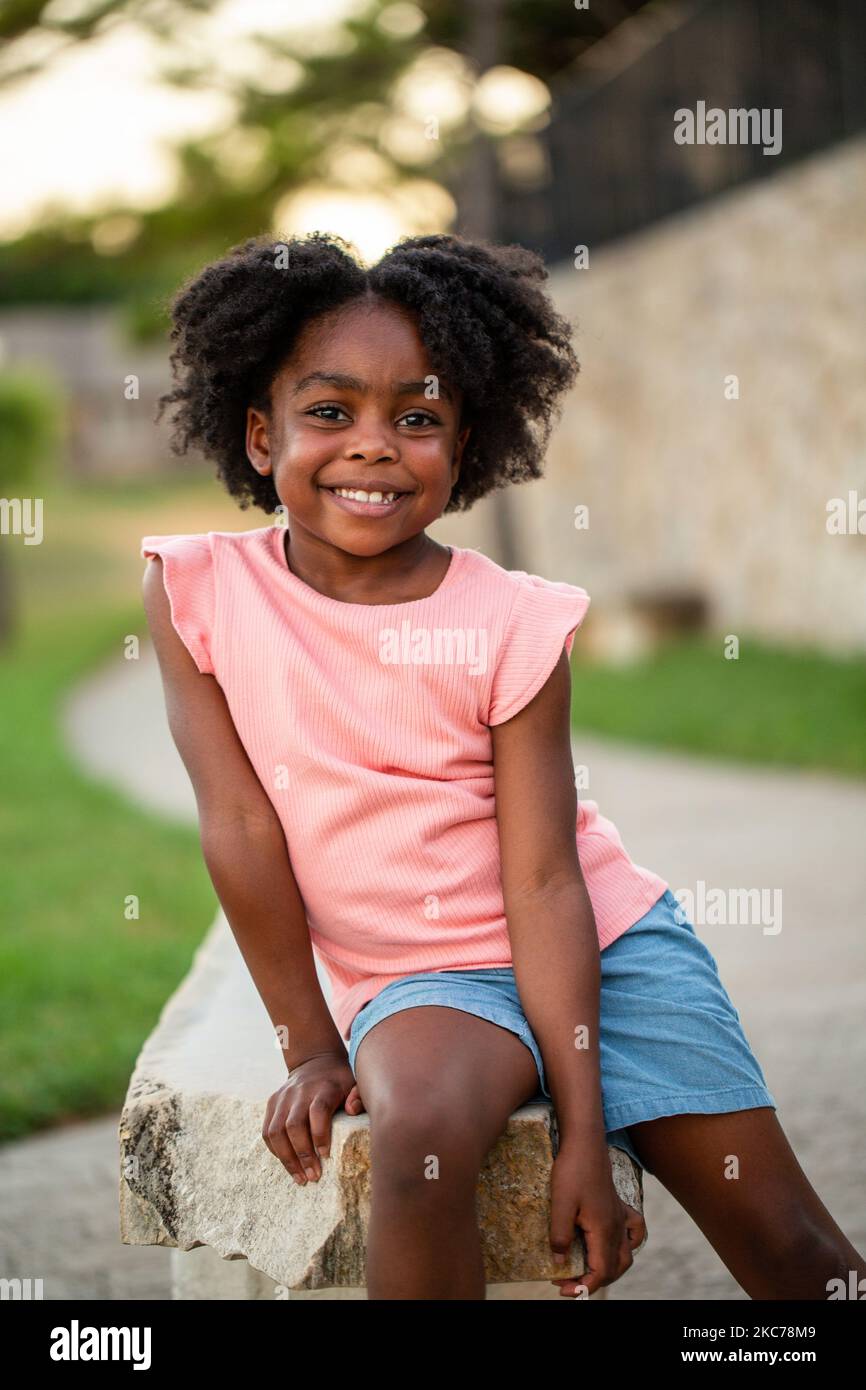 African Amerian little girl smiling outside Stock Photo - Alamy