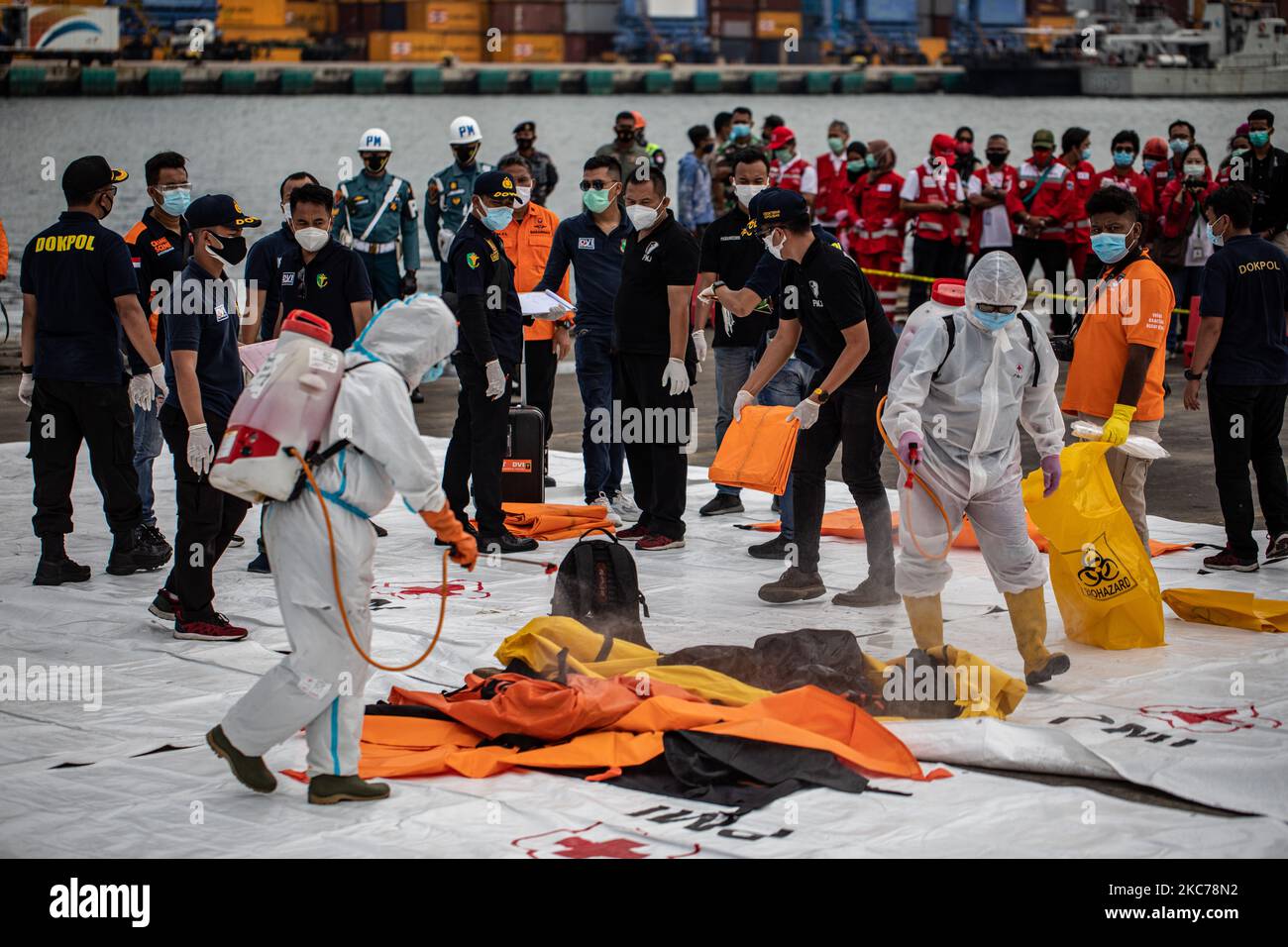 Officer spray disinfectant from the bag of the bodies victim of air plane crash. Cooperative