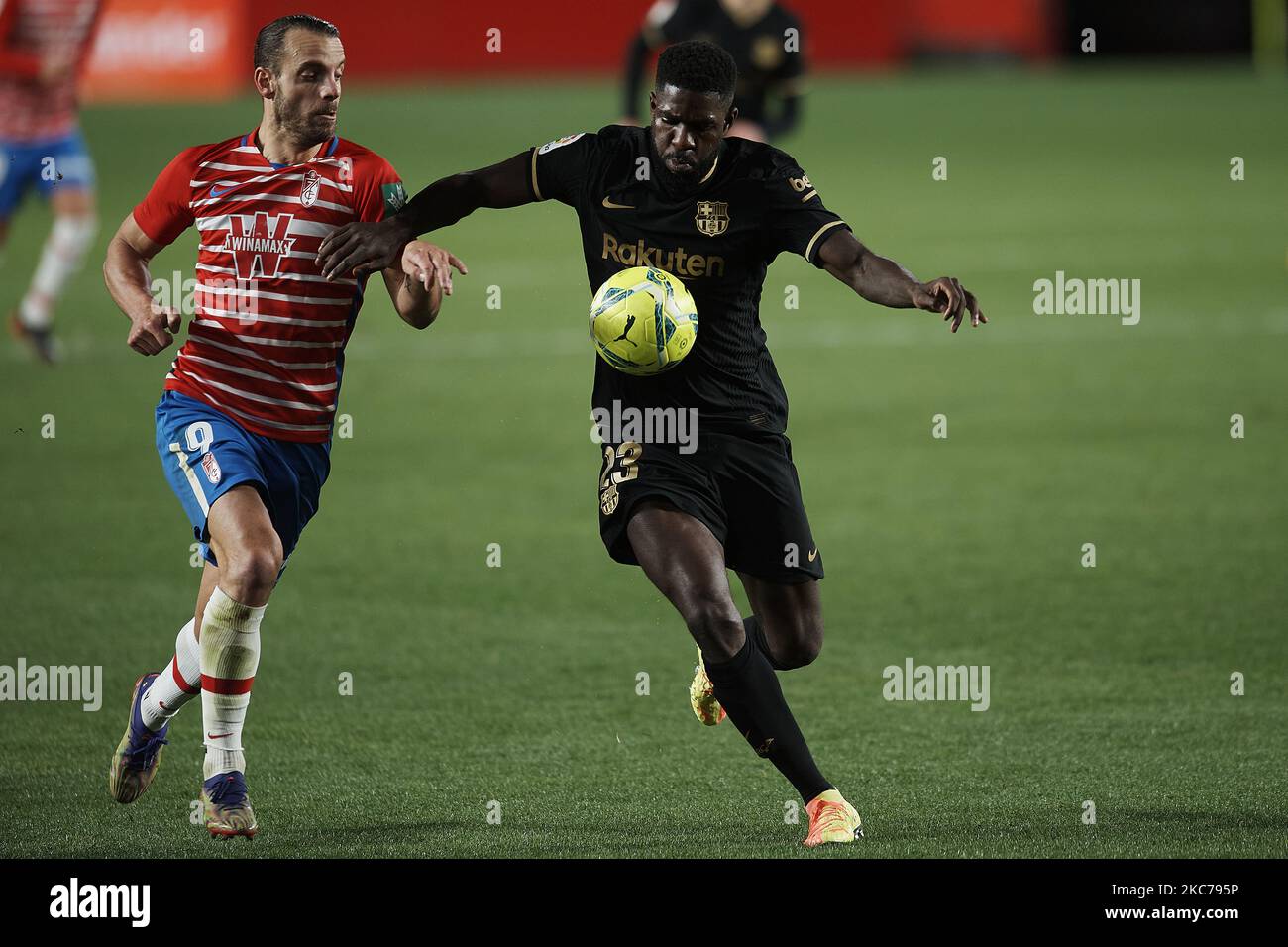 Roberto Soldado of Granada and Samuel Umtiti of Barcelona compete for the ball during the La Liga Santander match between Granada CF and FC Barcelona at Estadio Nuevo Los Carmenes on January 9, 2021 in Granada, Spain. Sporting stadiums around Spain remain under strict restrictions due to the Coronavirus Pandemic as Government social distancing laws prohibit fans inside venues resulting in games being played behind closed doors. (Photo by Jose Breton/Pics Action/NurPhoto) Stock Photo