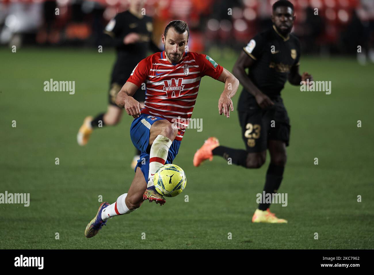 Roberto Soldado of Granada runs with the ball during the La Liga Santander match between Granada CF and FC Barcelona at Estadio Nuevo Los Carmenes on January 9, 2021 in Granada, Spain. Sporting stadiums around Spain remain under strict restrictions due to the Coronavirus Pandemic as Government social distancing laws prohibit fans inside venues resulting in games being played behind closed doors. (Photo by Jose Breton/Pics Action/NurPhoto) Stock Photo