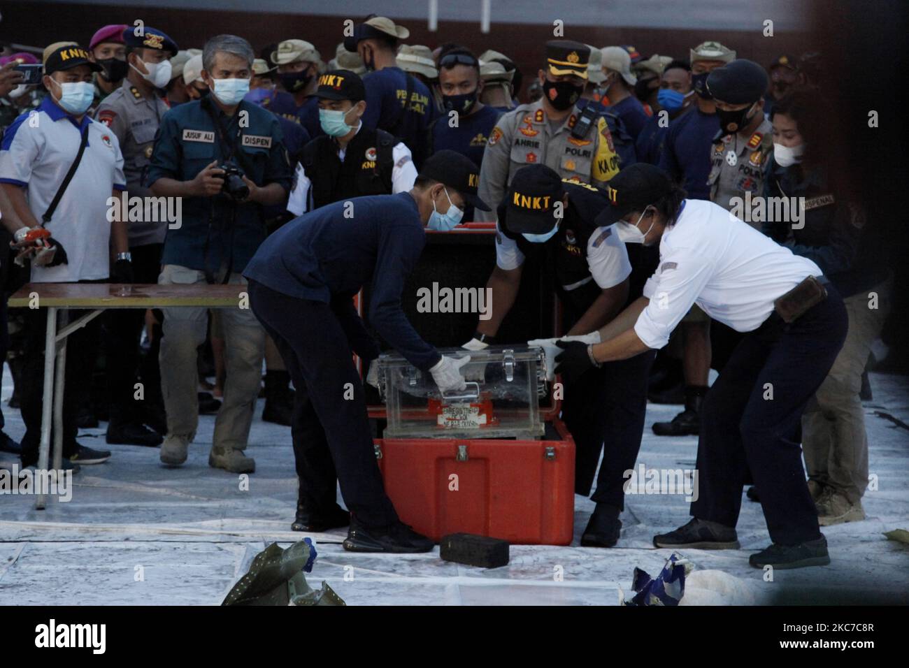Indonesian National Safety Transportation Commite personnels put the Flight Data Recorder (FDR) of crashed Sriwijaya Air Fliight SJ182 to the box after recovered from the crash site, at port of Tanjung Priok, North Jakarta, on January 12, 2021. The Sriwijaya Air flight SJ182 with 62 peoples on board are crash into the water of Jakarta coast mintues after take of from Soekarno-Hatta International Airport on January, 9. (Photo by Aditya Irawan/NurPhoto) Stock Photo