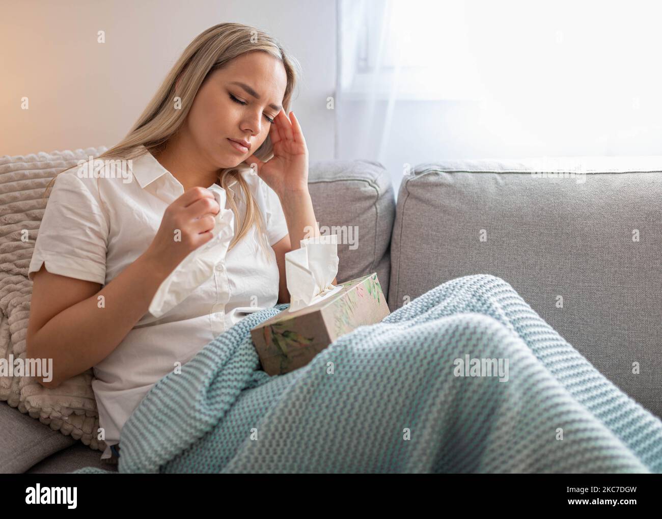 Portrait of tired young woman suffering from headache Stock Photo