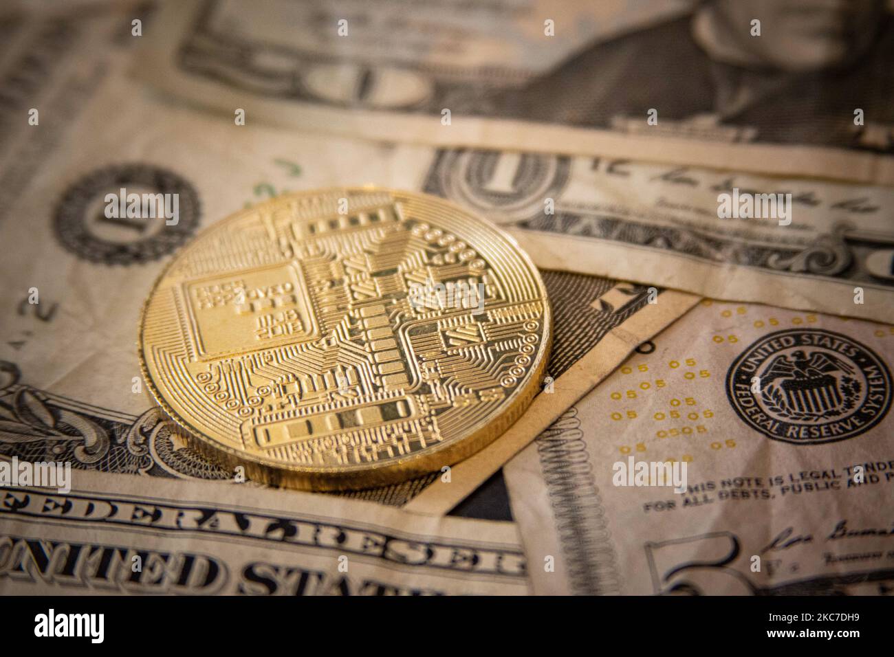 Bitcoin golden physical coin illustration on United States Dollar  banknotes. Visual representations of the digital Cryptocurrency Bitcoin  with the USD bill. Bitcoin with the symbol BTC, XBT is a popular digital  currency