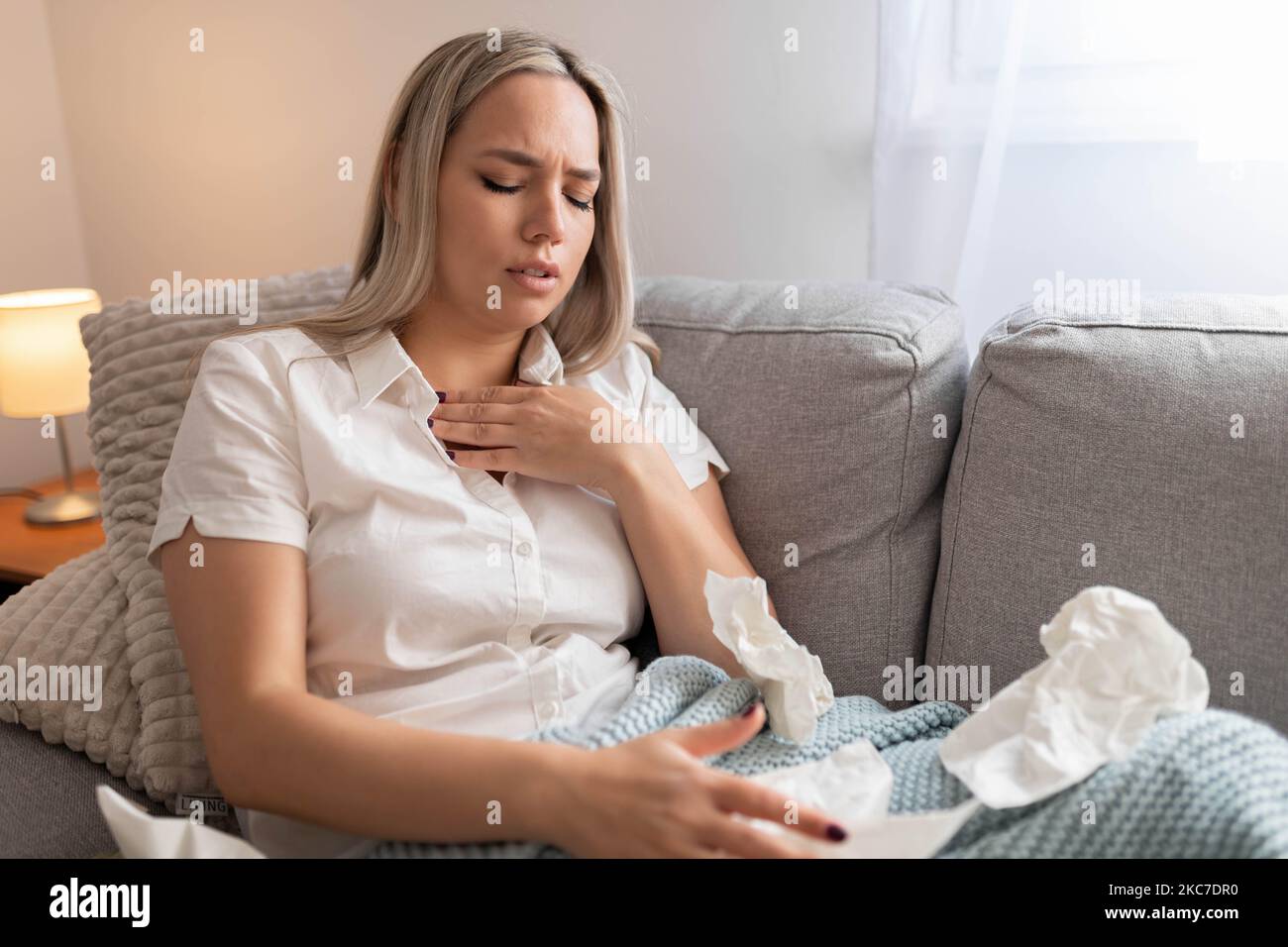 Woman having chest pain. respiratory system diseases. Girl having a heart attack at home. Stock Photo