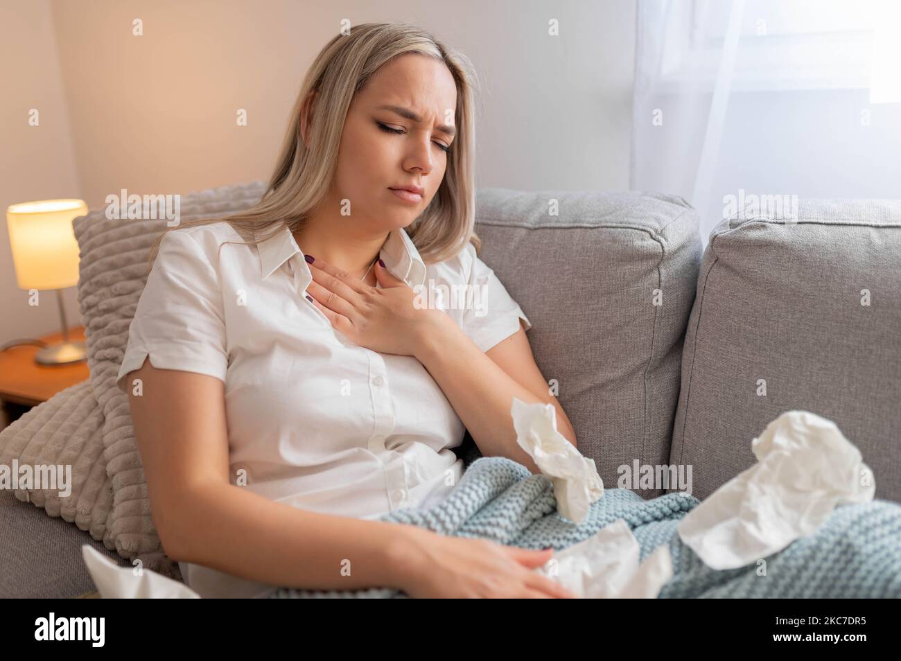 Woman having chest pain. respiratory system diseases. Girl having a heart attack at home. Stock Photo
