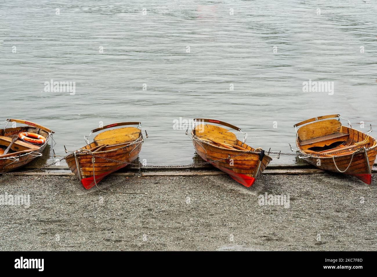 The four small, wooden boats on the shore Stock Photo - Alamy