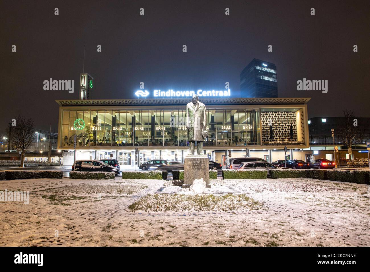 Eindhoven Centraal, the centra train station of the city with the inscription on top of it and the statue of Philips in front of the building as seen during the snowfall. Night long exposure photography images of snow-covered and illuminated with city lights Eindhoven city center after the snowfall. Daily life in the Netherlands with the first snowfall of the year covering almost everything the cold weather shows subzero temperature. The chilly condition with snow and ice changed soon according to the forecast, the freezing condition will not last more than a day. Eindhoven, the Netherlands on Stock Photo