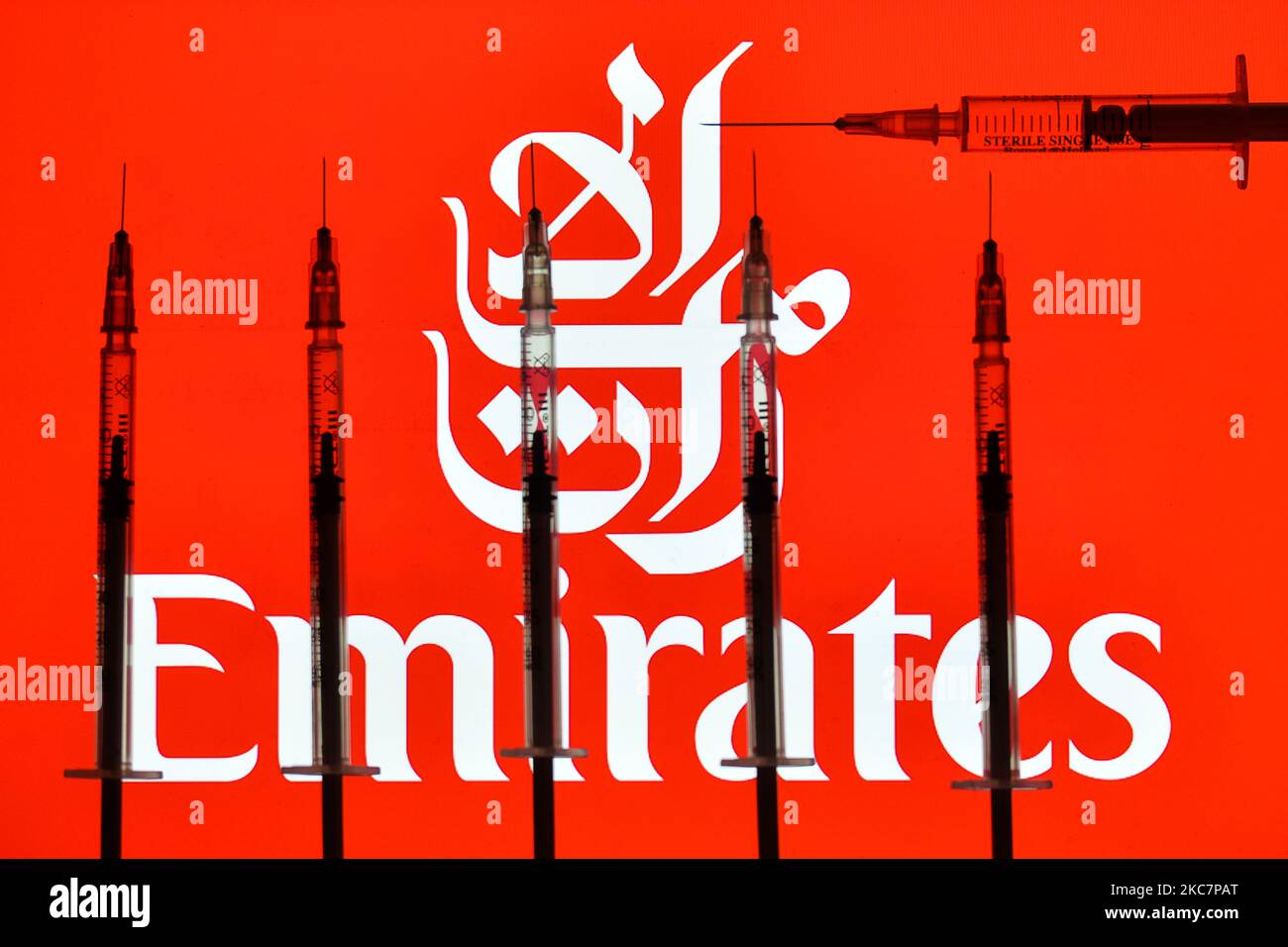 An illustrative image of medical syringes in front of a Emirates logo displayed on a screen. On Monday, January 18, 2021, in Dublin, Ireland. (Photo by Artur Widak/NurPhoto) Stock Photo