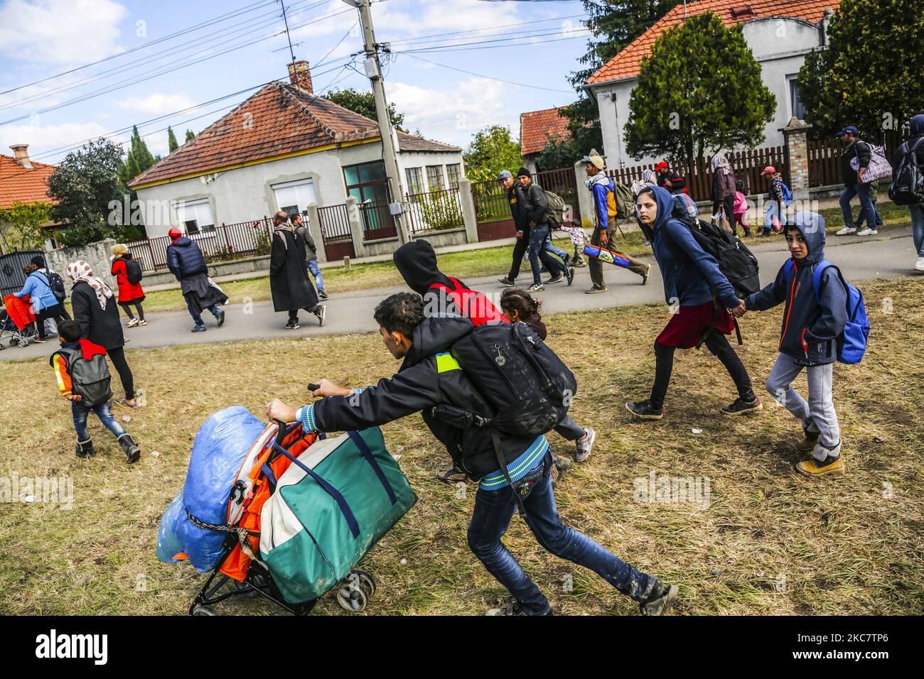 Refugees walk to the Hungarian-Austrian border between Hegyeshalom and Nickelsdorf, after they arrived by train to Hegyeshalom, Hungary on 28 September 2015. A record number of refugees from the Middle East, Africa and Asia are using the so-called Balkans route to enter the EU. (Photo by Beata Zawrzel/NurPhoto) Stock Photo