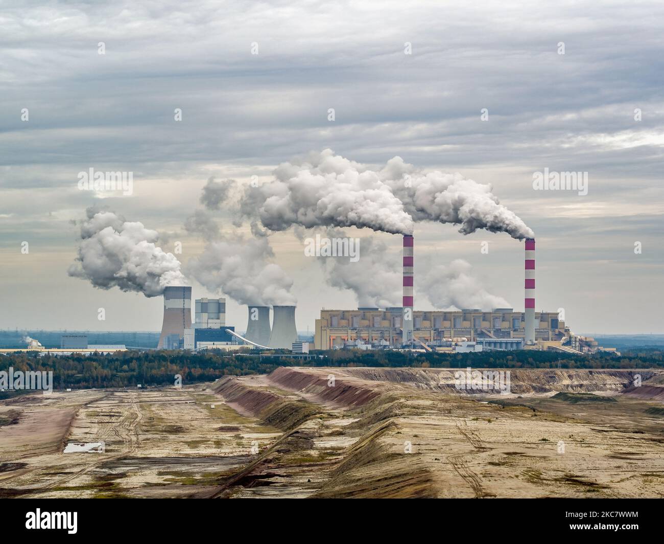 Aerial view of power plant and open-cast coal mine in Belchatow under moody cloudy sky, Poland Stock Photo
