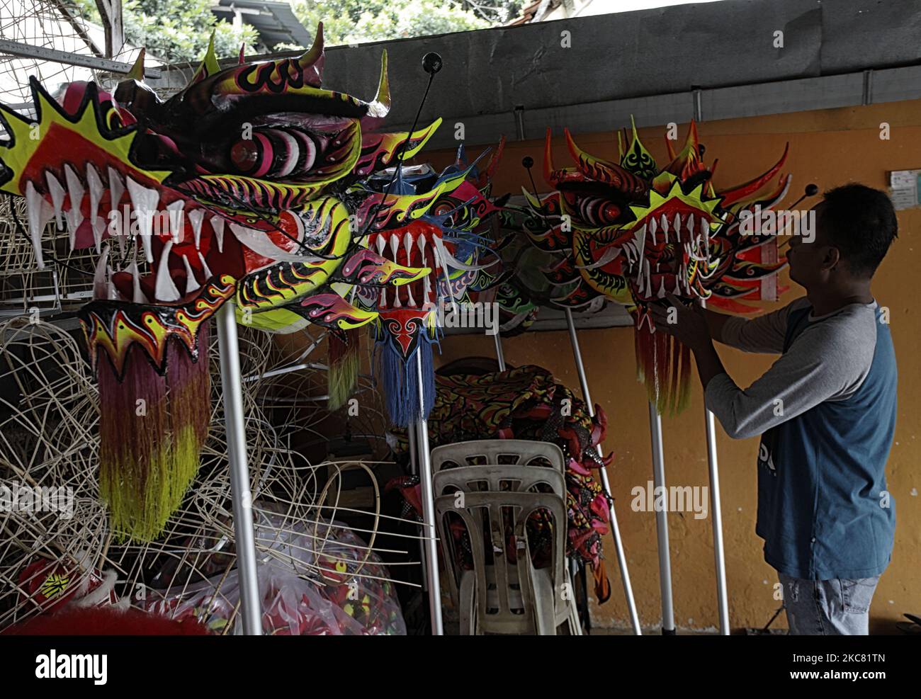 Lili Hambali, 49, a maker of lion (Barongsai) and Liong (dragon) dance costumes, inspects his creations inside his house ahead of Lunar New Year celebrations, in Bogor, West Java, Indonesia on January 23, 2021. Millions of Chinese around the world will celebrate the Lunar New Year, 2021 is the year of the Ox, which falls on February 12th amid the global coronavirus COVID-19 pandemic. (Photo by Adriana Adie/NurPhoto) Stock Photo